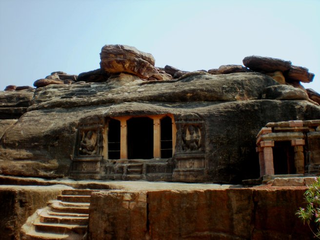 A cave temple carved into a rock.